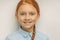 Close-up portrait of positive child girl with red hair