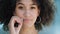 Close-up portrait of pretty African American girl with afro hairstyle zipping lips, locking mouth. Young ethnic model