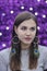 Close-up portrait of pretty girl in dreamcatcher earrings with peacock feathers, bohemian accessories