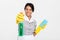 Close-up portrait of professional housekeeper in uniform and yellow rubber gloves spraying the cleaner on you