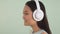 Close-up portrait profile. Asian girl in big headphones listens to music and dances 4K