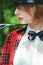 Close-up portrait in profile of beautiful young woman in horsewoman suit in forest