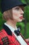 Close-up portrait in profile of beautiful young woman in horsewoman suit in forest