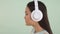 Close-up portrait profile. Cute Asian girl Devshuka in big headphones listens to music and dances 4K