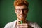 Close-up portrait of readhead bearded photographer in glasses, h