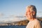 Close up and portrait of sad and pensive man looking at the sea in the beach - upset people lifestyle concept