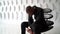 Close-up portrait of a sad and thoughtful bearded middle-aged African-American man posing sitting on an unusual chair in