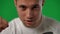 Close-up portrait of satisfied young sportsman with brown eyes looking at camera gesturing success. Front view headshot