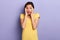 Close-up portrait of scared cute emotional charming girl with palms on cheeks