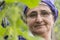 Close-up portrait of a senior Muslim woman gardening cucumber pl