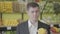Close-up portrait of serious Caucasian man choosing pear in grocery shop. Handsome guy smelling yellow fruit with