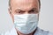 Close up portrait of serious man in special medic mask. He is looking serious. Mature experienced doctor.