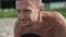 Close up portrait shirtless man standing yoga pose, smiling and relaxing on beach.