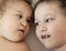 Close-up portrait of siblings lying on bed. Boy loves his disabled younger brother. - image