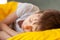 Close up Portrait Sleeping child on soft light background. Little boy sleeping in yellow bed