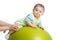 Close-up portrait of smiling baby on fitness ball. Exercise and massage, baby health conception