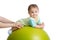 Close-up portrait of smiling baby on fitness ball. Exercise and massage, baby health conception