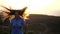 Close up portrait of smiling feminine girl running and looking to camera in rural landscape. Attractive young lady is