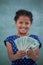 Close up portrait of smiling girl showing paper currency