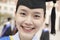 Close Up portrait of smiling young female graduate wearing a mortarboard