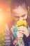 Close-up portrait of smiling young girl holding bouquet of flowers in hands. Girl with yellow dandelions. Smiling face of teenager