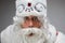 Close up portrait of studio surprised shocked Santa Claus on gray background, candid emotions, body language