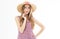 Close-up portrait of stunning blonde woman with hair waving posing cute smile. Adorable young woman in straw hat enjoying summer