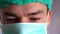 Close up portrait of a surgeon or doctor with mask and headset ready for operation in hospital or clinic. Close up