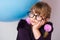 Close-up portrait of a teenage girl wearing glasses