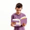 Close up portrait of teenaged disabled boy with cerebral palsy looking focused while reading a book, standing isolated