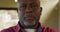 Close up portrait of thoughtful african american senior man looking straight to camera