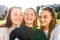 Close-up portrait, three girls schoolgirls teenagers, summer outdoors. Happy smiling play, Photography phone, selfie