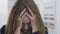 Close up portrait of tired lady in formal clothes with tousled hair having headache in the office. Woman grabbing her