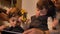 Close-up portrait of two arabic curly-headed twin boys watching attentively into tablet holding toy.