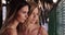 Close-up portrait of two beautiful Caucasian women posing in calm beach setting