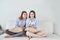 Close up portrait of two excited girlfriends with mobile phones, laughing.