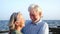 close up and portrait of two happy and active seniors or pensioners having fun and enjoying looking at the camera smiling with the