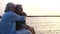 Close up and portrait of two happy and active seniors or pensioners having fun and enjoying looking at the sunset smiling with the