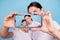 Close-up portrait of two nice people wearing casual white t-shirt holding in hands device making taking selfie photo