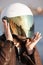 Close-up portrait of unrecognizable European female motorcyclist with white open face helmet with mirrored tinted visor