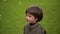 Close up portrait of a very cute young boy who catches soap bubbles. slow-motion