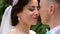 Close-up portrait of wedding couple touching noses