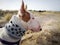 Close up portrait of white ginger spotted English bull terrier bullterrier on a beach