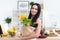 Close-up portrait of a woman holding paper bag full fresh vegetables. Happy smiling female vegetarian with grocery.