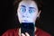 Close up portrait of a woman looking at her mobile phone like a zombie. Black background. The concept of online addiction