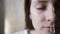 Close-up portrait of a woman - natural skin care using moisturizer. Stroking a face with a brush for applying makeup