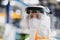 Close-up portrait of worker with protective mask and suit in industrial factory.