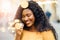 Close up portrait of young african girl with afro hairstyle. Girl wearing pink jacket, posing on yellow background