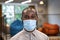 Close up portrait of a young afro american man, male office worker in protective face mask, looking at camera while