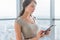 Close-up portrait of a young attractive freelancer using tablet for telework, typing and reading new messages on-line.